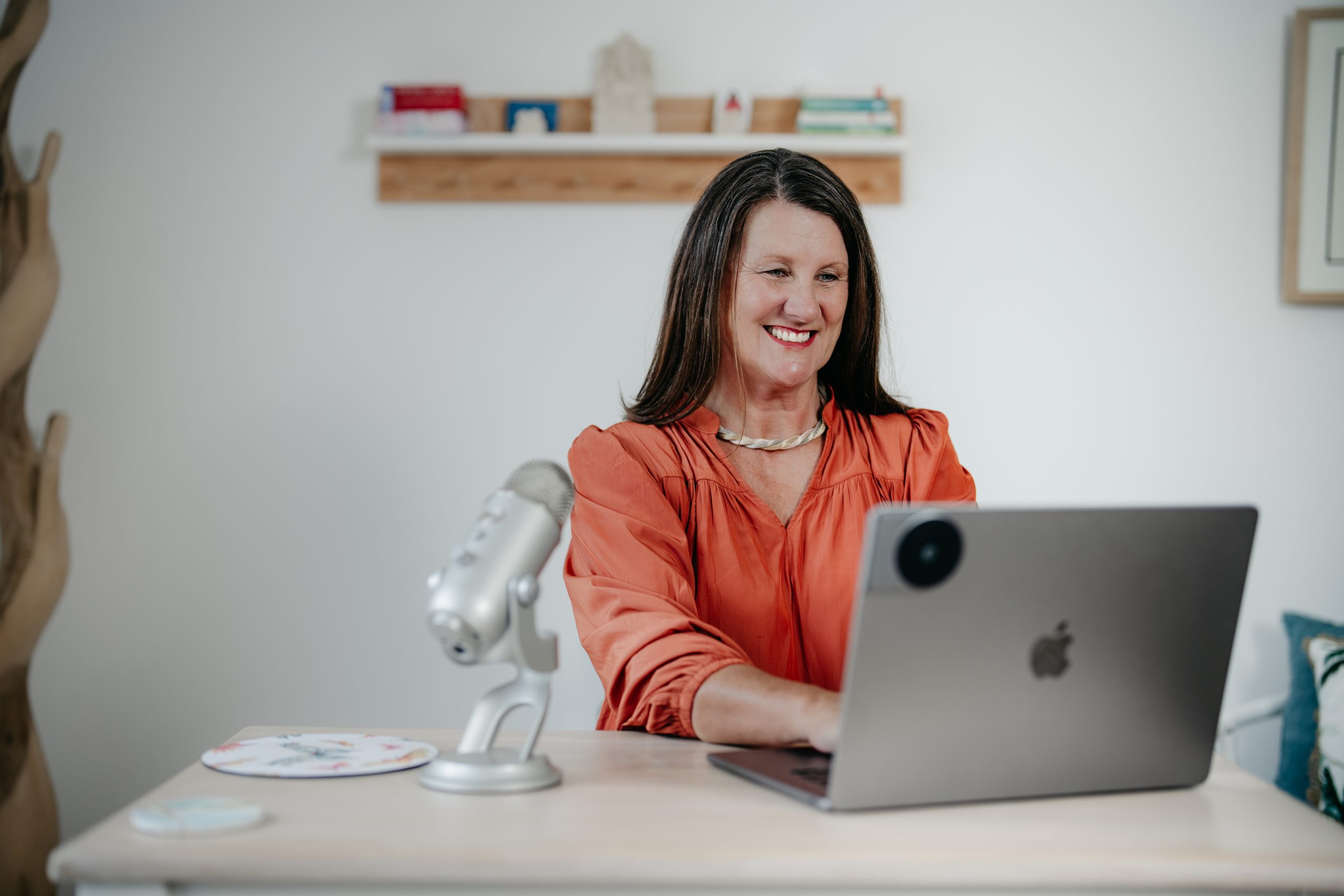 Rebecca Hannan typing a reflective post on her laptop